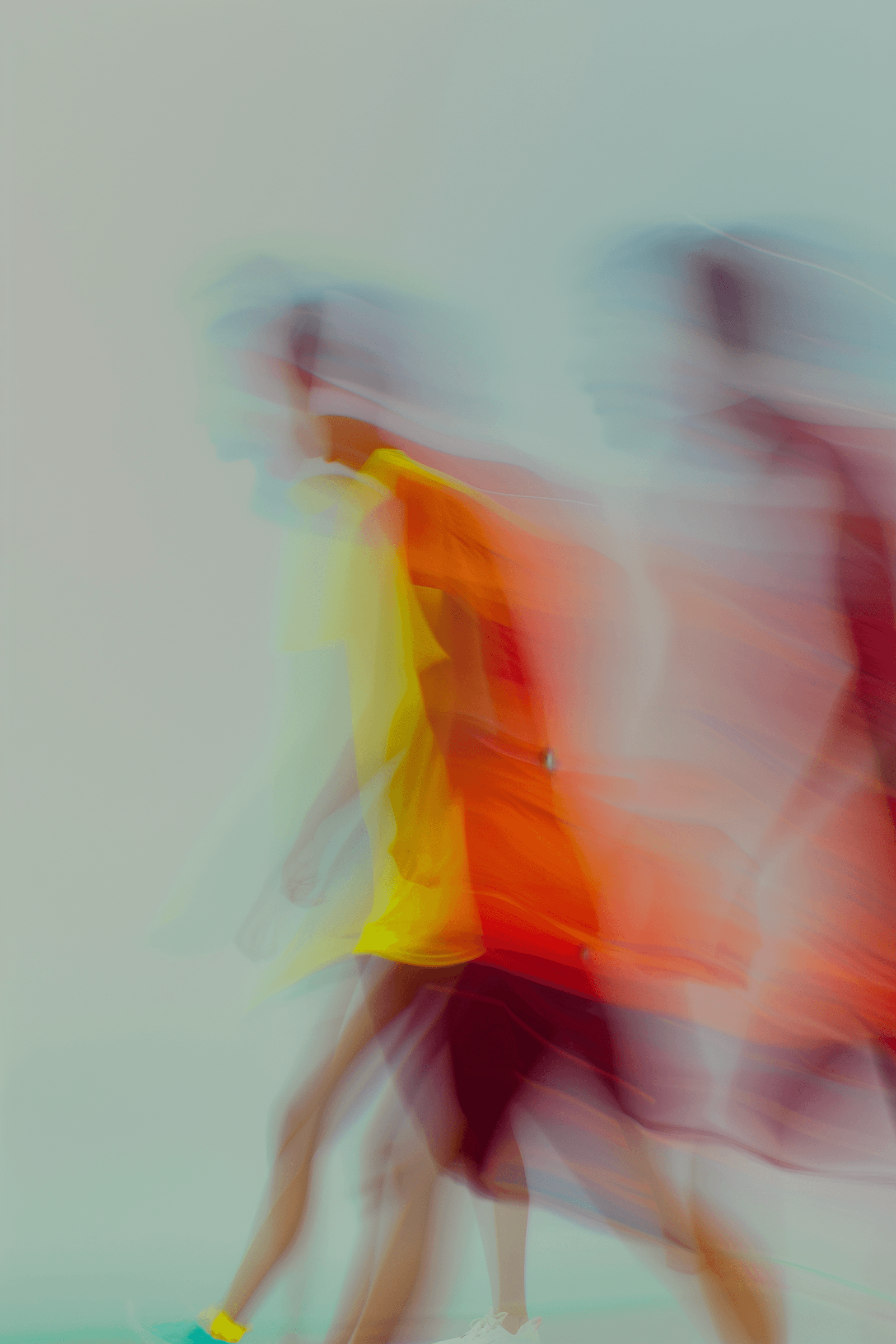Two men walking at a festival, captured with soft motion blur and warm orange tones.