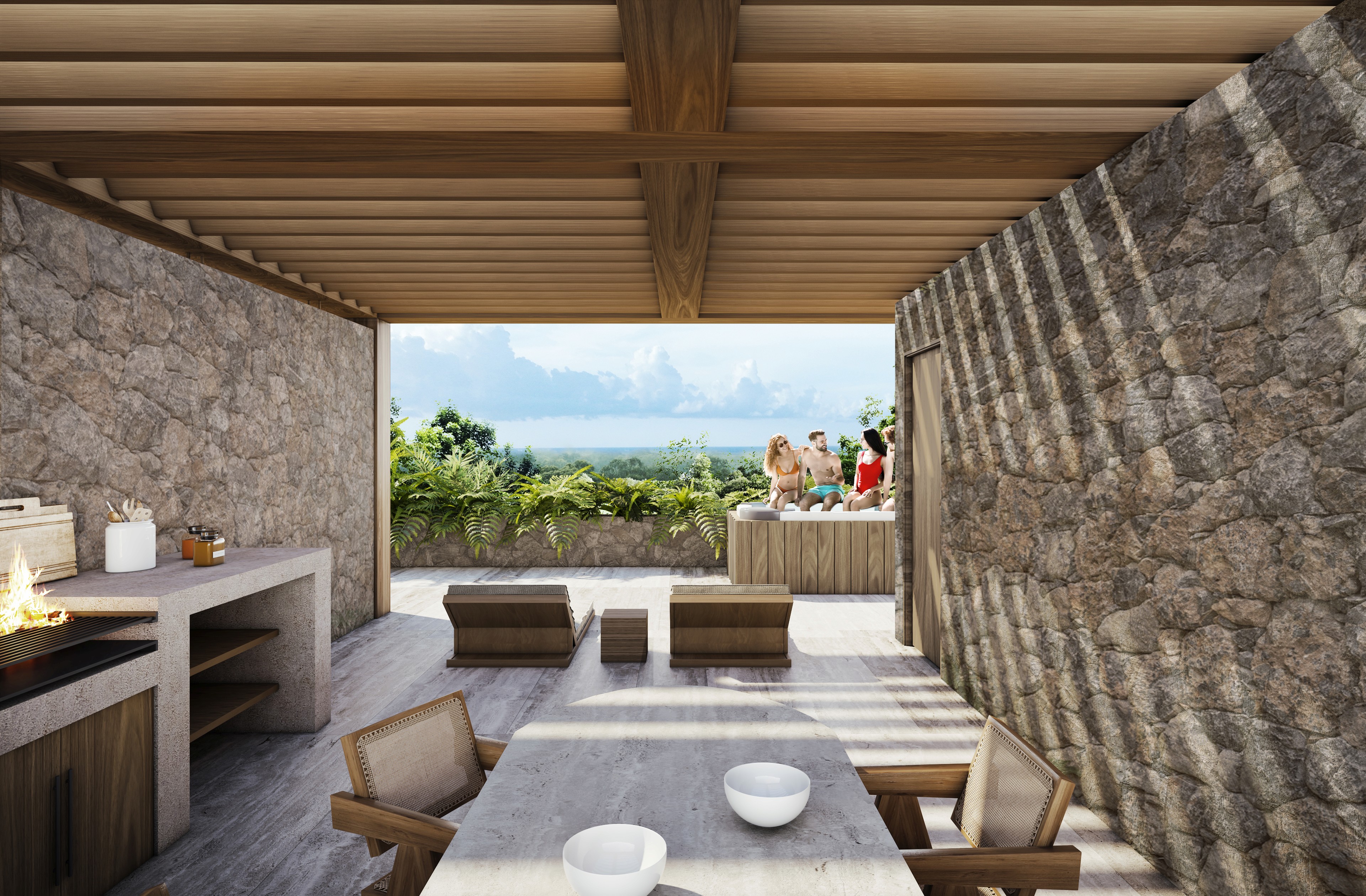 Smiling young woman with curly hair sitting at a laptop, in front of a teal wall.