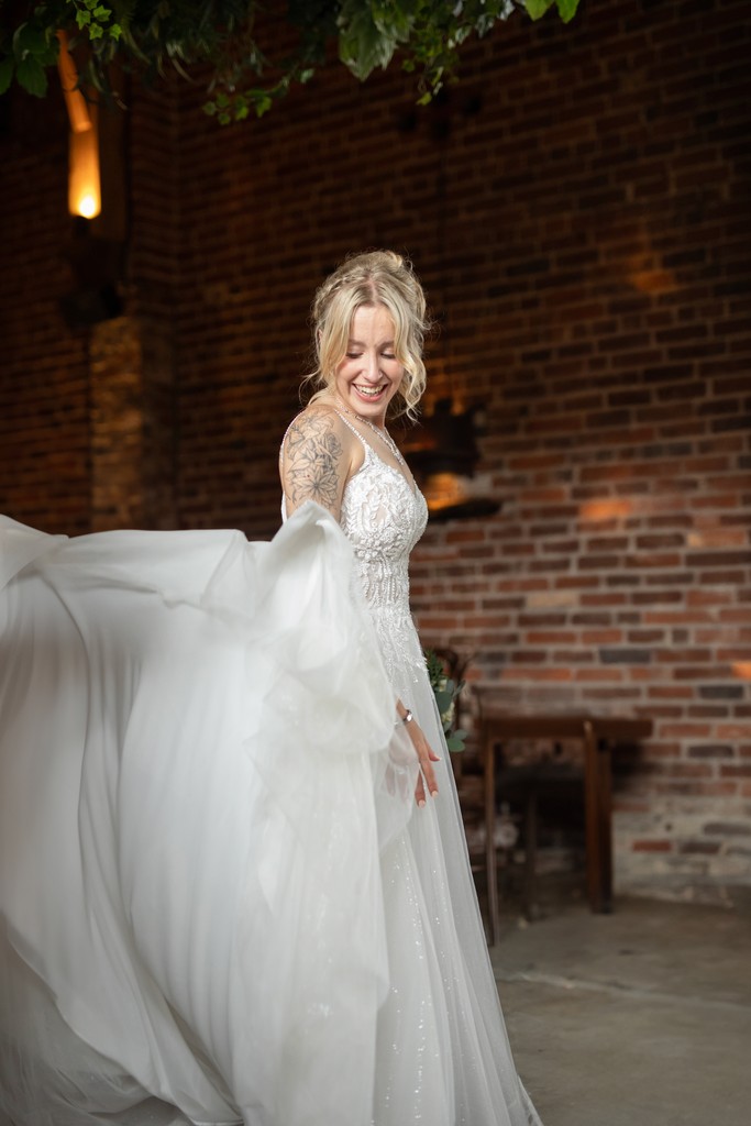 A woman in a straw hat stands in the grass