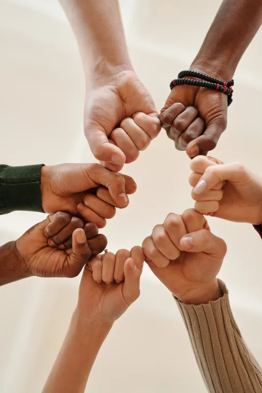 Hands fist bumping together in a circle
