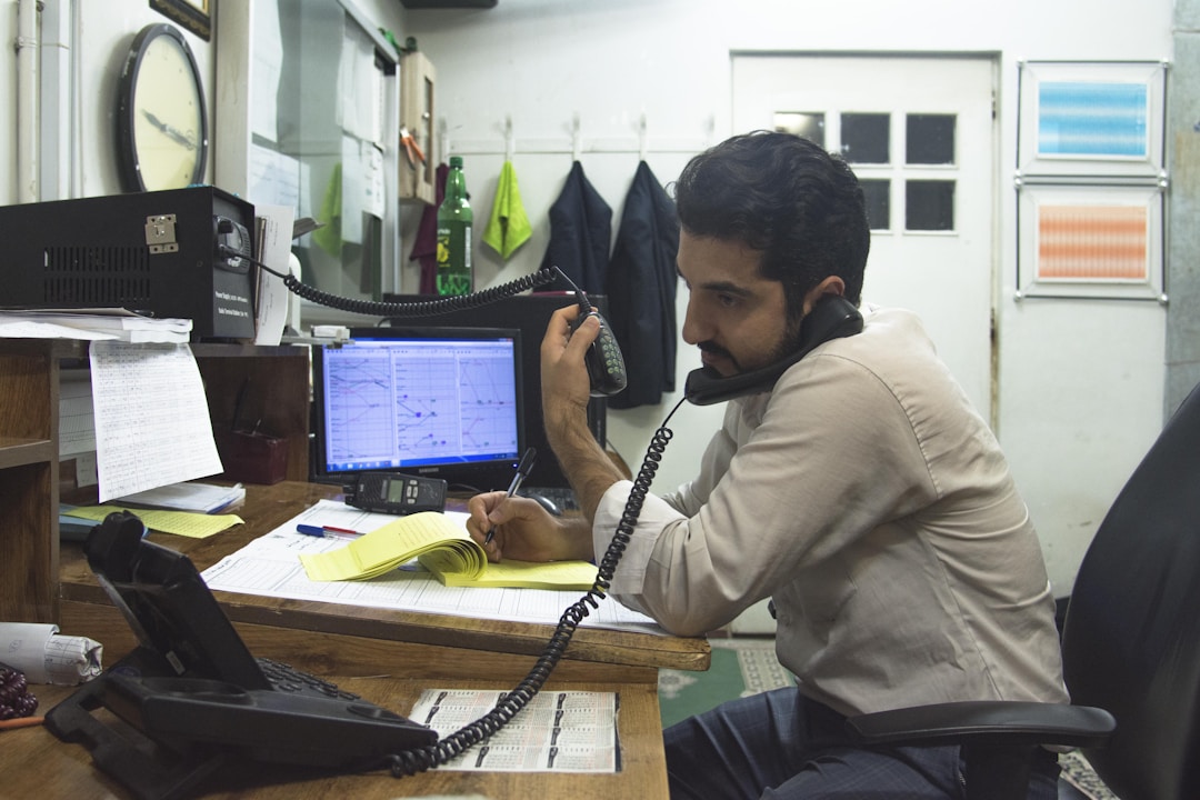 remote worker at desk with laptop managing investments
