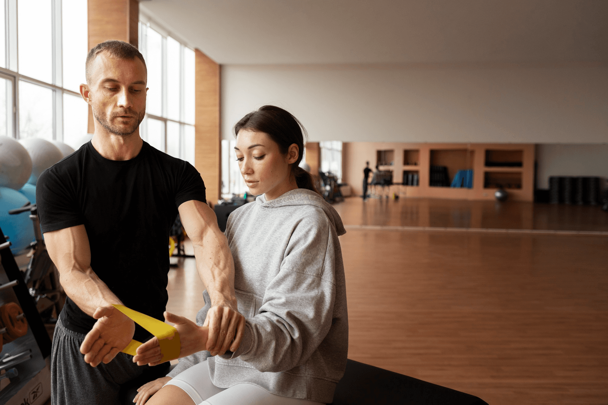 A woman being guided by a acorrective exercise specialist.