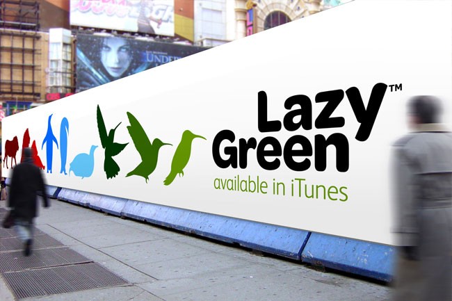 A large white banner on a city sidewalk displays the text "Lazy Green" in black letters, with "available in iTunes" written below in green text. Below the text are five colorful bird silhouettes: blue, green, and three shades of green. A person walks past the banner on the left side of the image, and a building facade is visible in the background.
