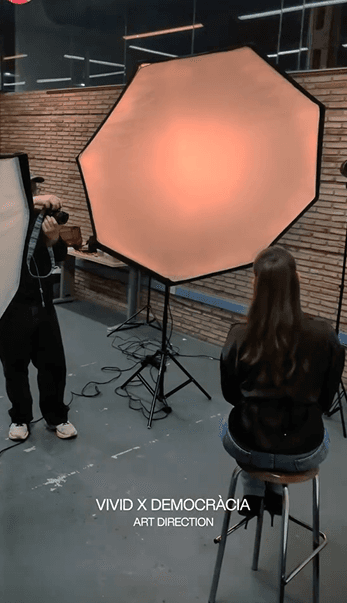 Students on a photo shoot with a large studio light