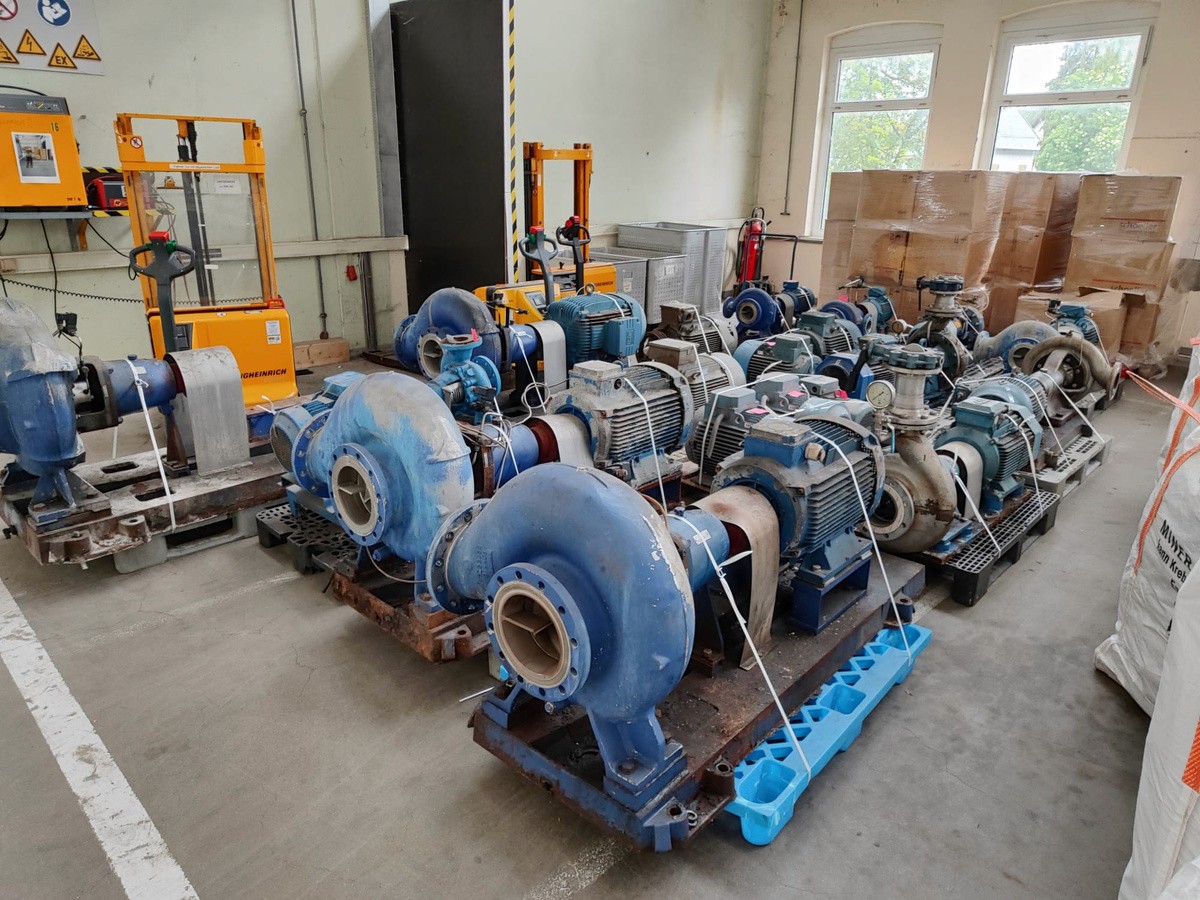 a group of metal poles against a cloudy blue sky