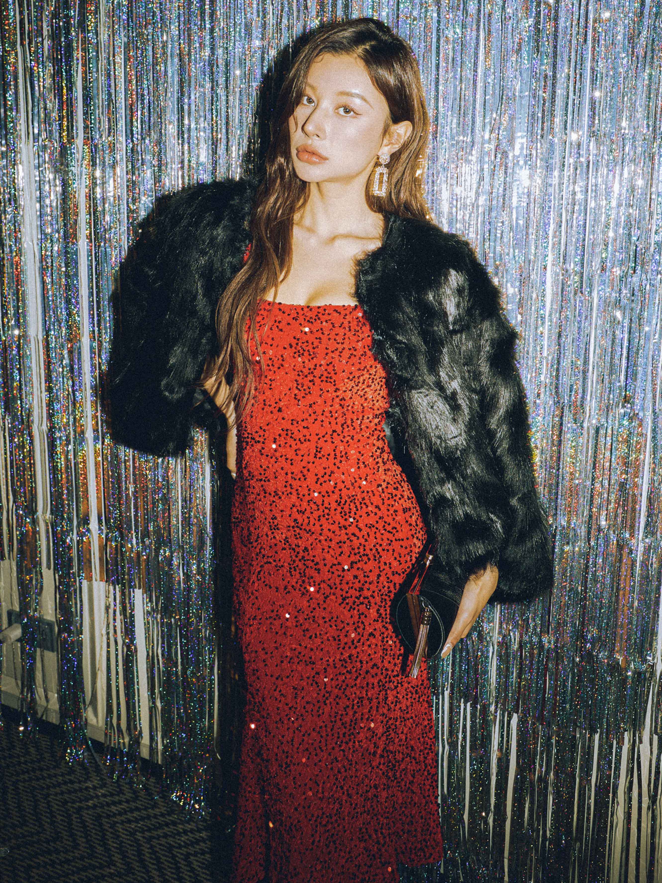 "Bold in a red sequin dress with a luxe fur jacket."