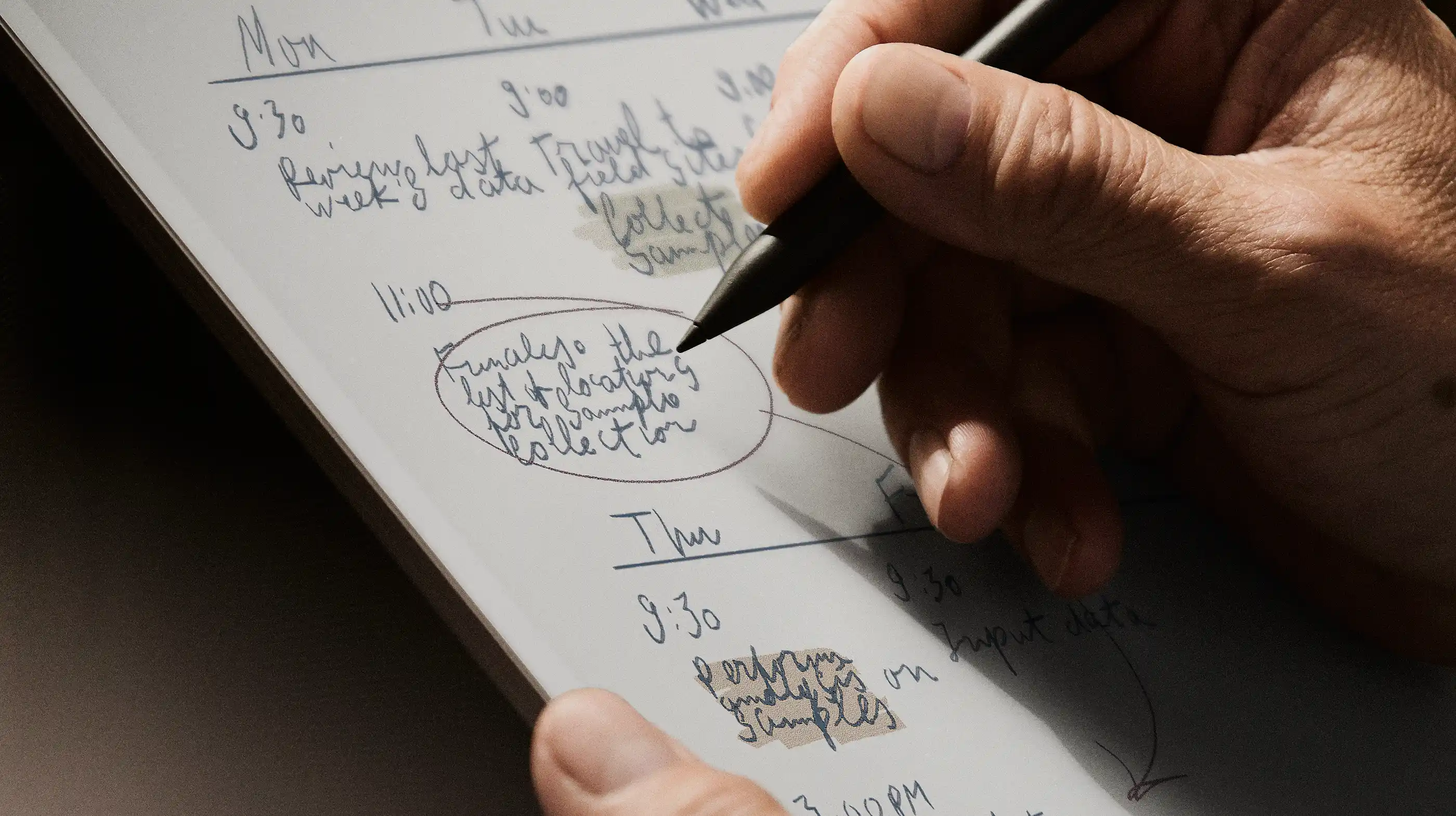 Person drawing on tablet with pen