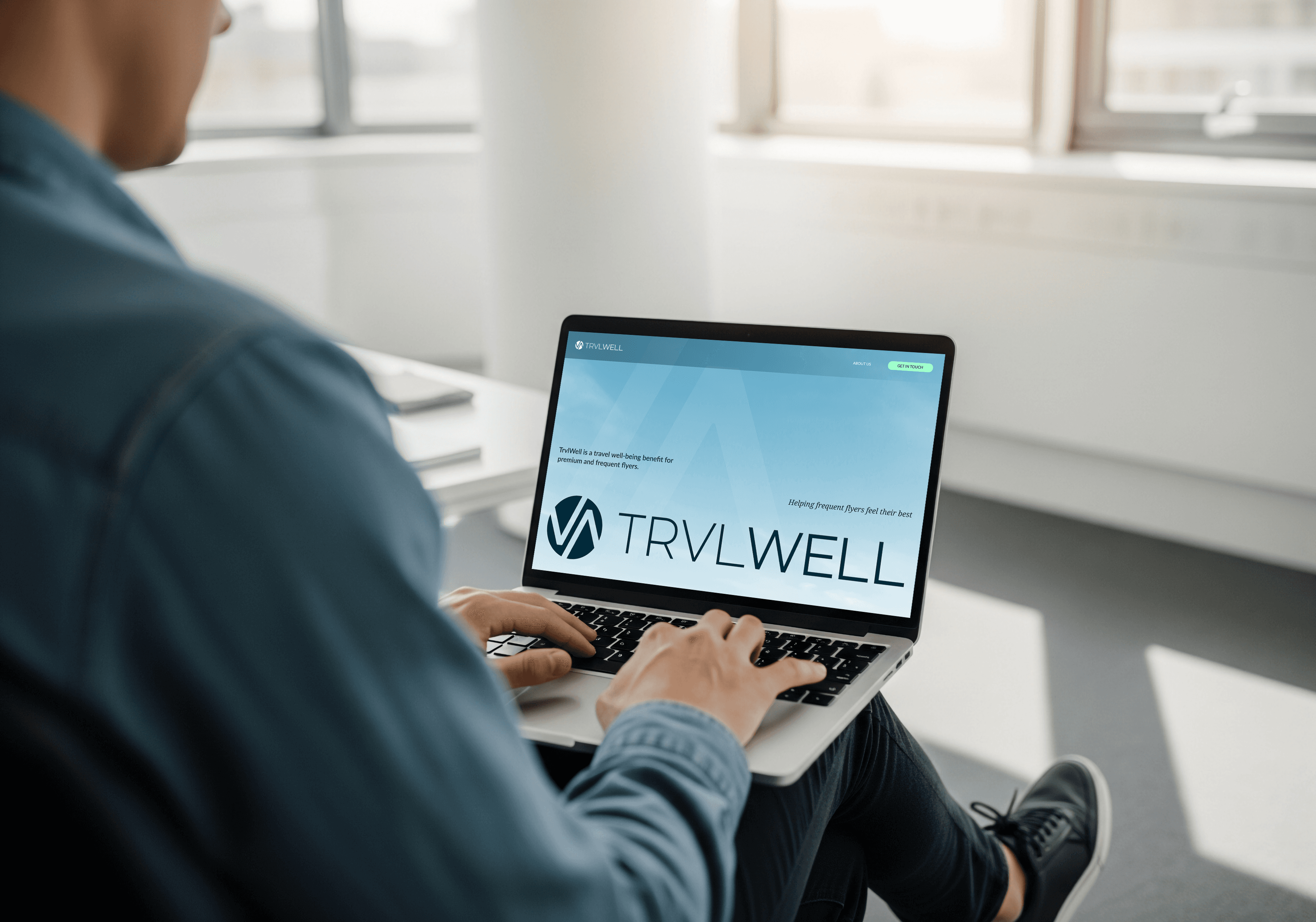 Man on lapop looking at TrvlWell website