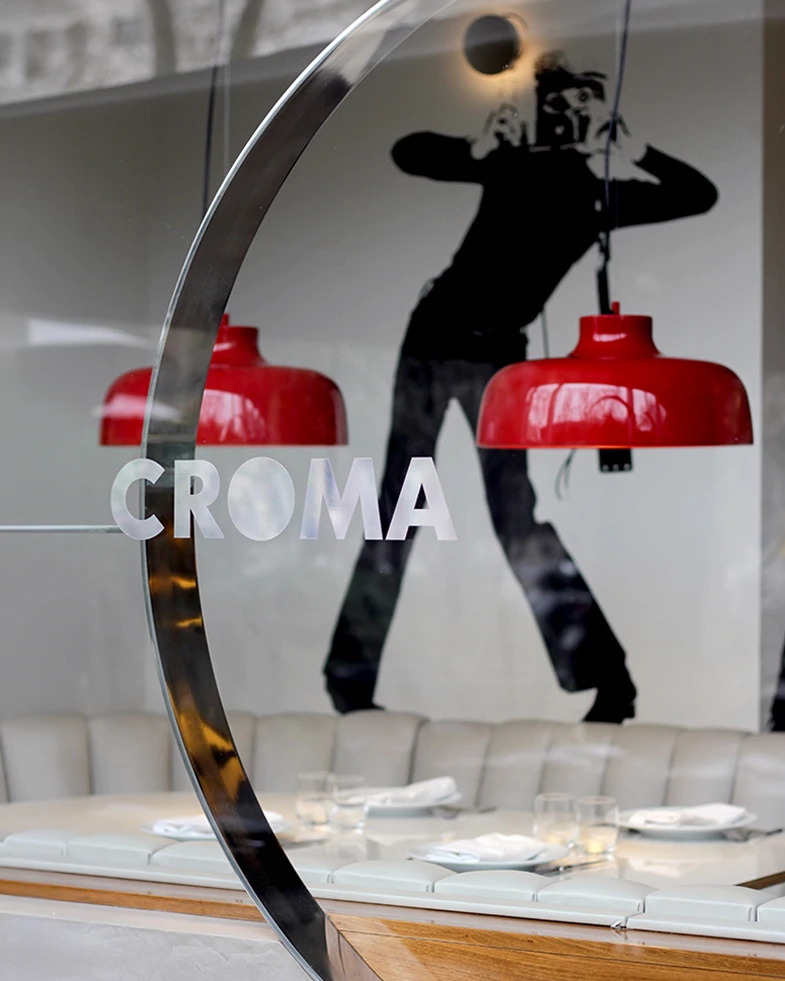 Croma logo and dancer silhouette on the restaurant's glass ring, brand identity design by Sebastian Saavedra