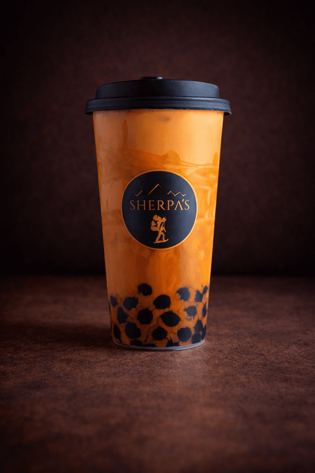 Thai Tea with condensed milk and tapioca pearls at Café Sherpa's, Brookfield WI. Bold spiced black tea that's earthy, creamy, and sweet.