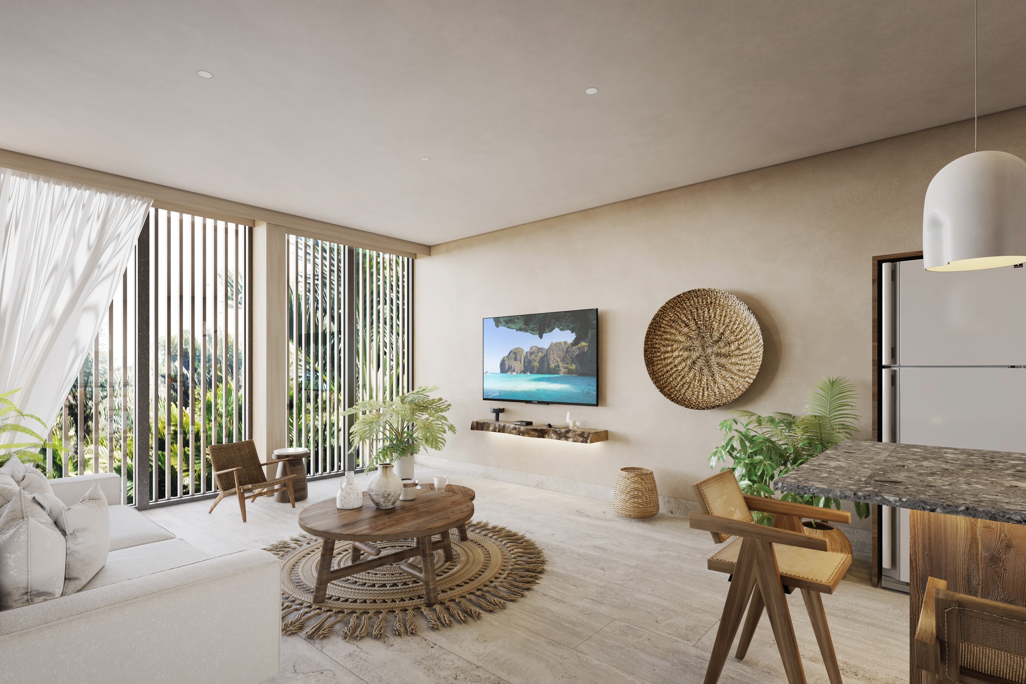 A young person with curly hair smiles at the camera while sitting in front of a laptop against a dark background.