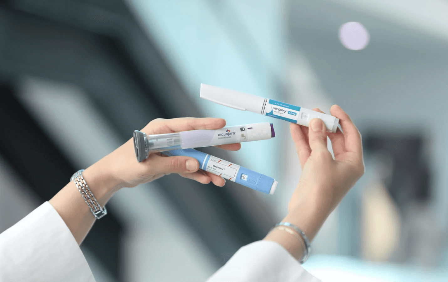 Person holding various injectable medication pens - Microdosing GLP 1