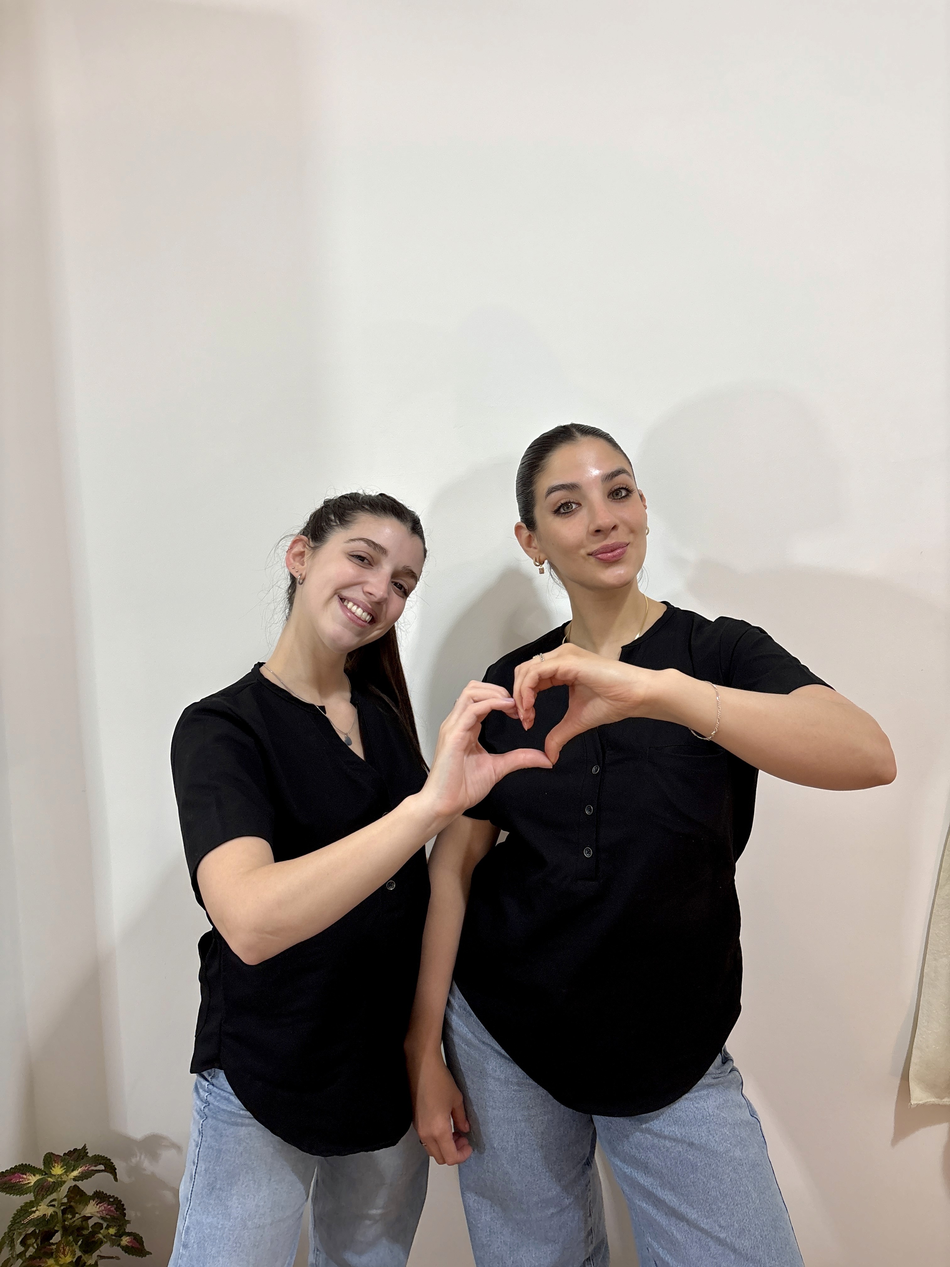 A cozy scene with warm sunlight casting stripes, featuring a potted plant and soft towels on a window sill.