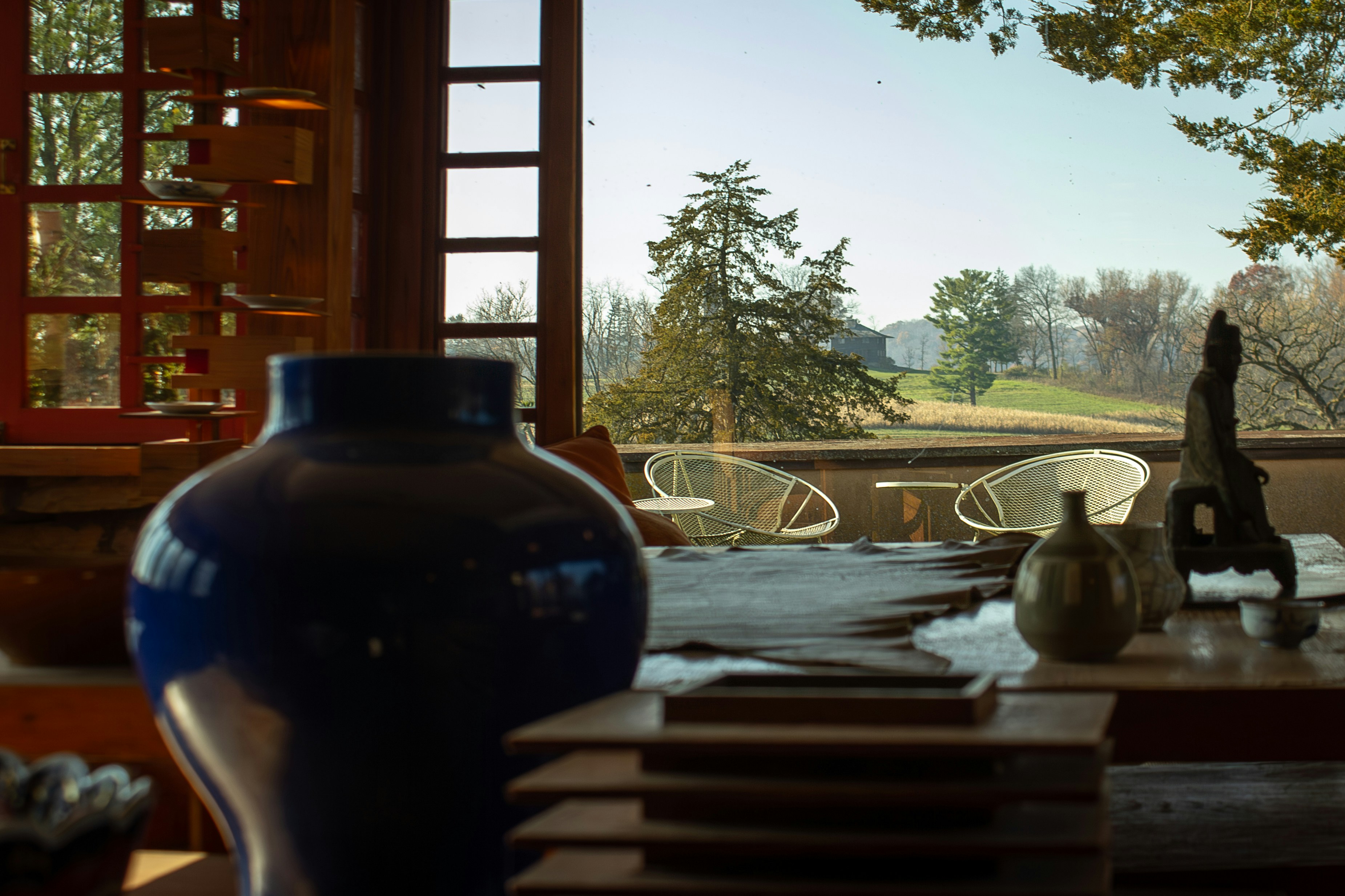 a vase sitting on top of a table next to a window