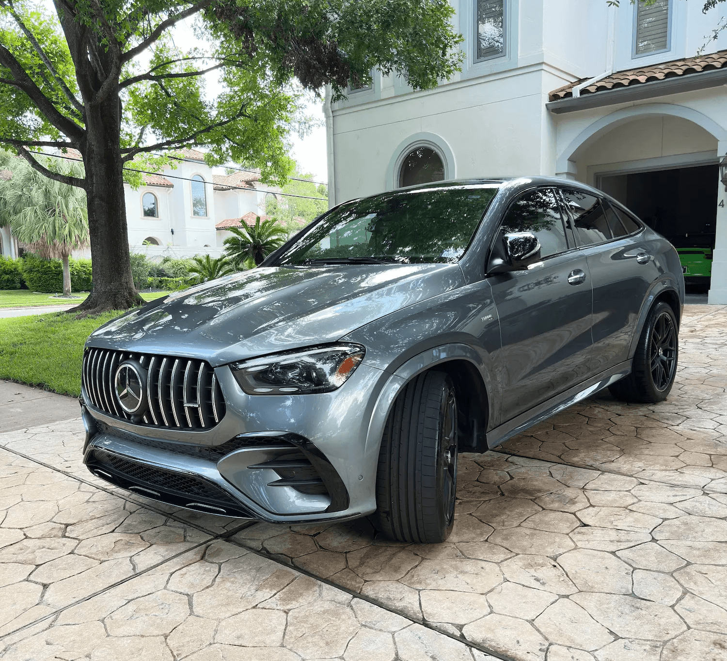 Mobile auto detailing in Houston showcasing a clean Mercedes-Benz SUV on a client's driveway.