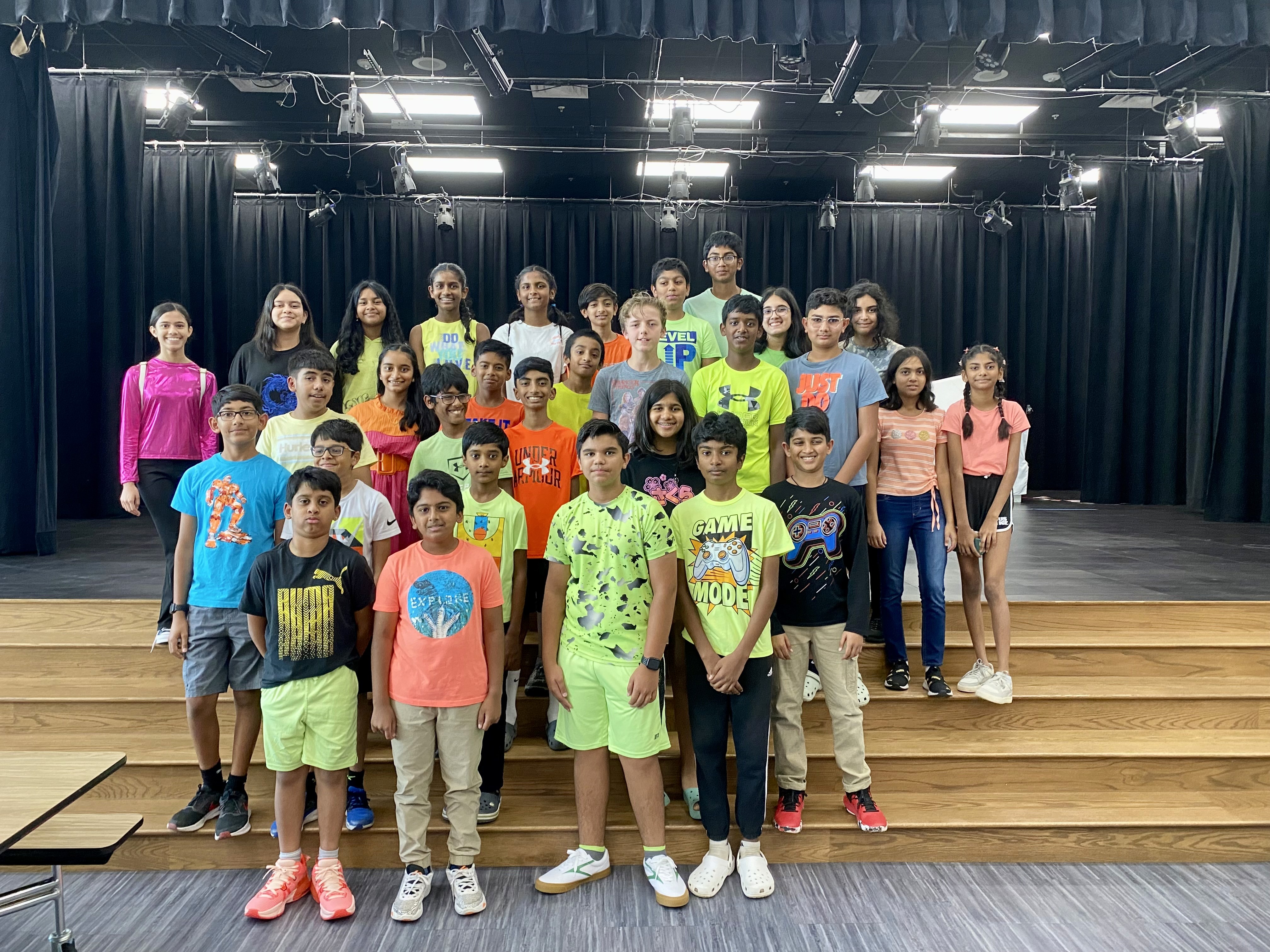 Students posing together on stage