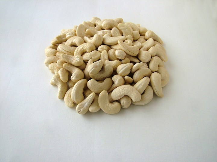 Cashew nuts arranged on a neutral surface; illustrative commodity photography
