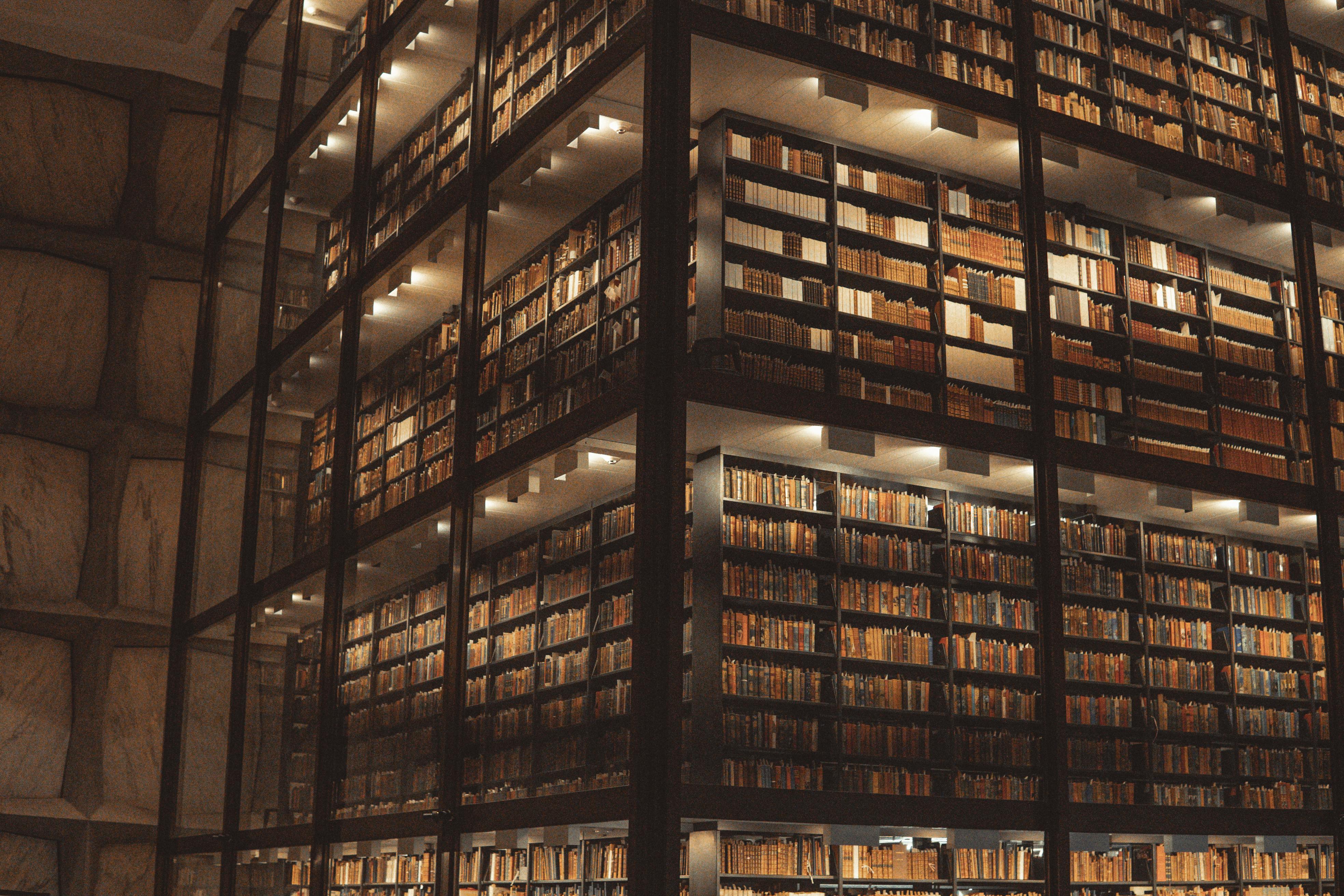 Shot of multiple storeys of a library and the shelves of books.