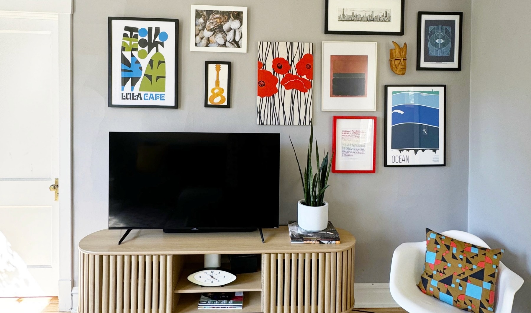 colorful and modern living room with gallery wall and tv entertainment center