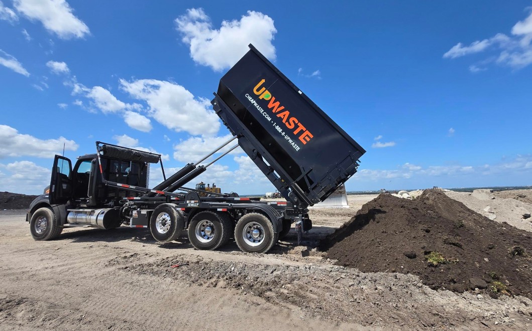 Dumpster truck unloading soil