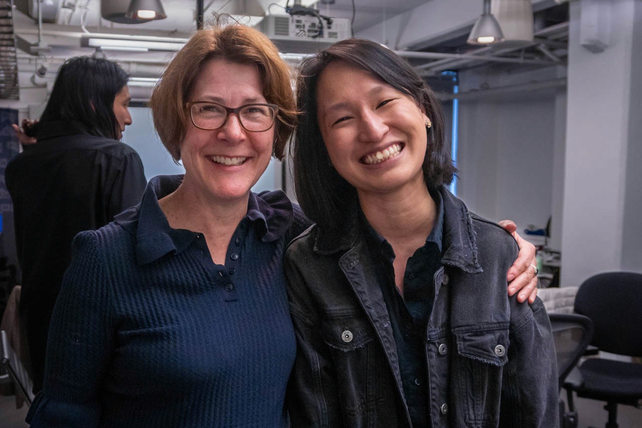 two people looking at the camera and smiling