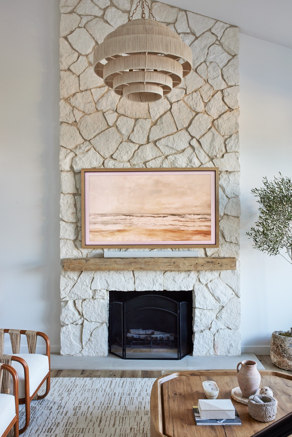 Luxury interior home design, grand centered limestone fireplace with timber accent beam focal point