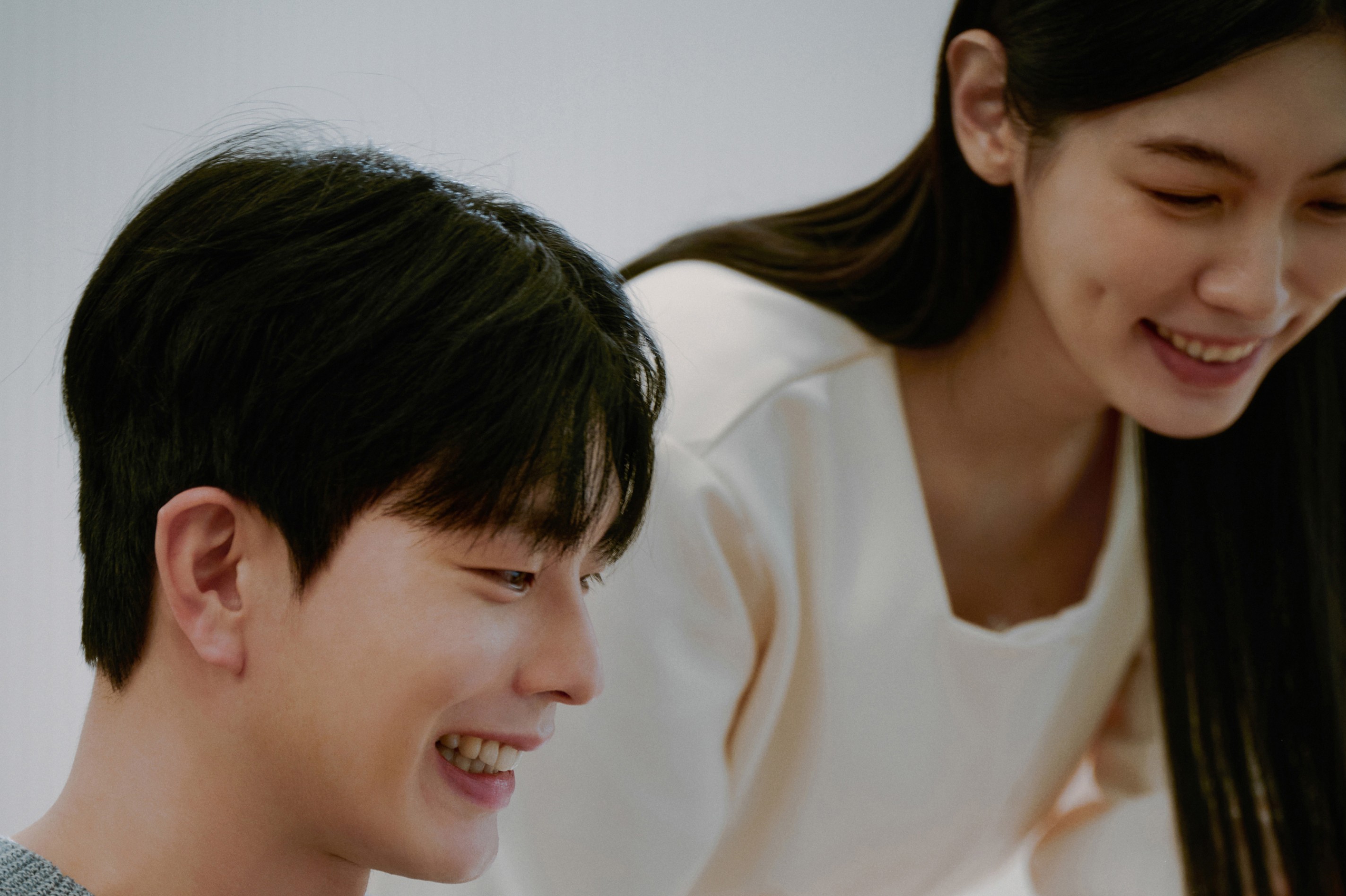 Two students smiling during a language learning session at 612 Academy, reflecting an engaging and human-centered learning experience.