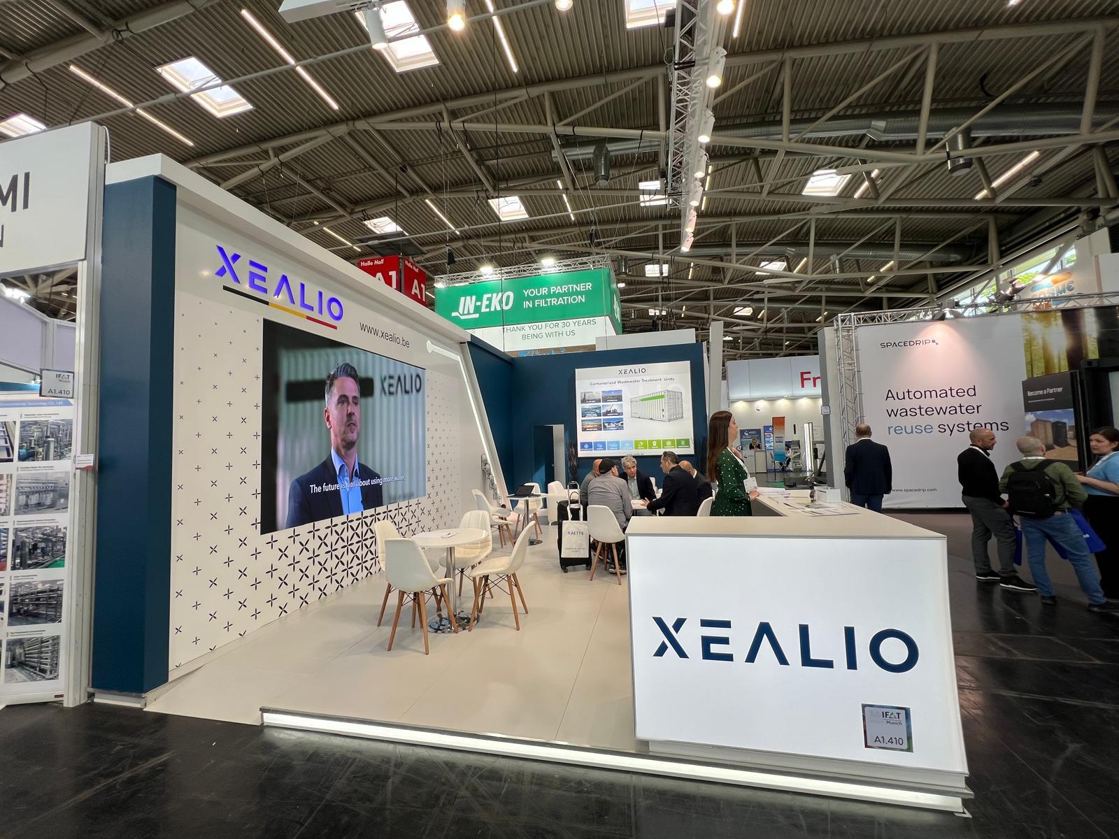 Reception counter at the Xealio stand, welcoming visitors and supporting visitor engagement with branded materials and professional presentation.