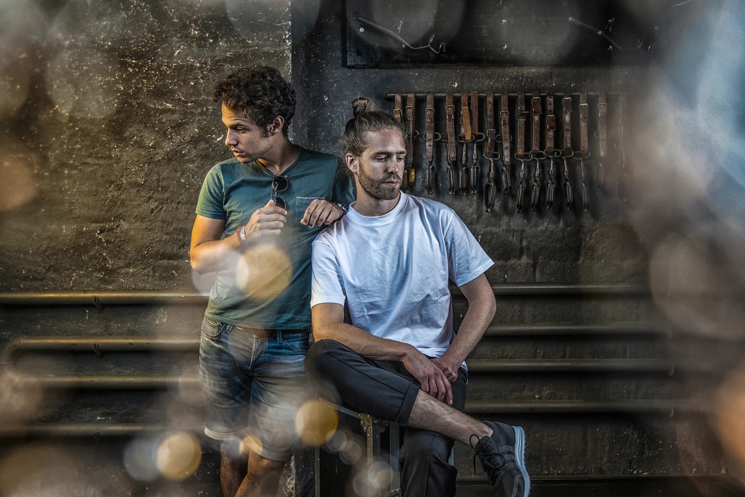 Candid and warm portrait of the duo Lo and Leduc sitting on backstage stairs.