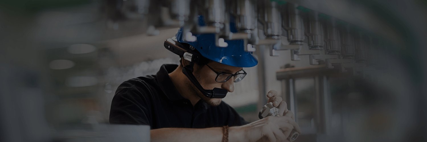 A photo of a frontline worker inspecting a production line