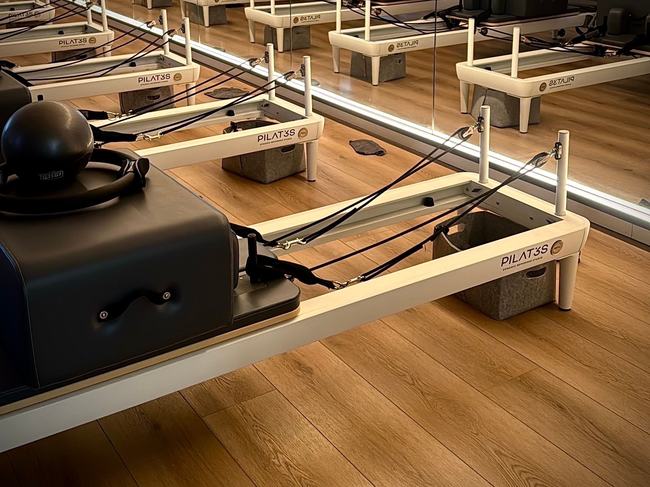 Pilates reformer session in a warm-toned studio