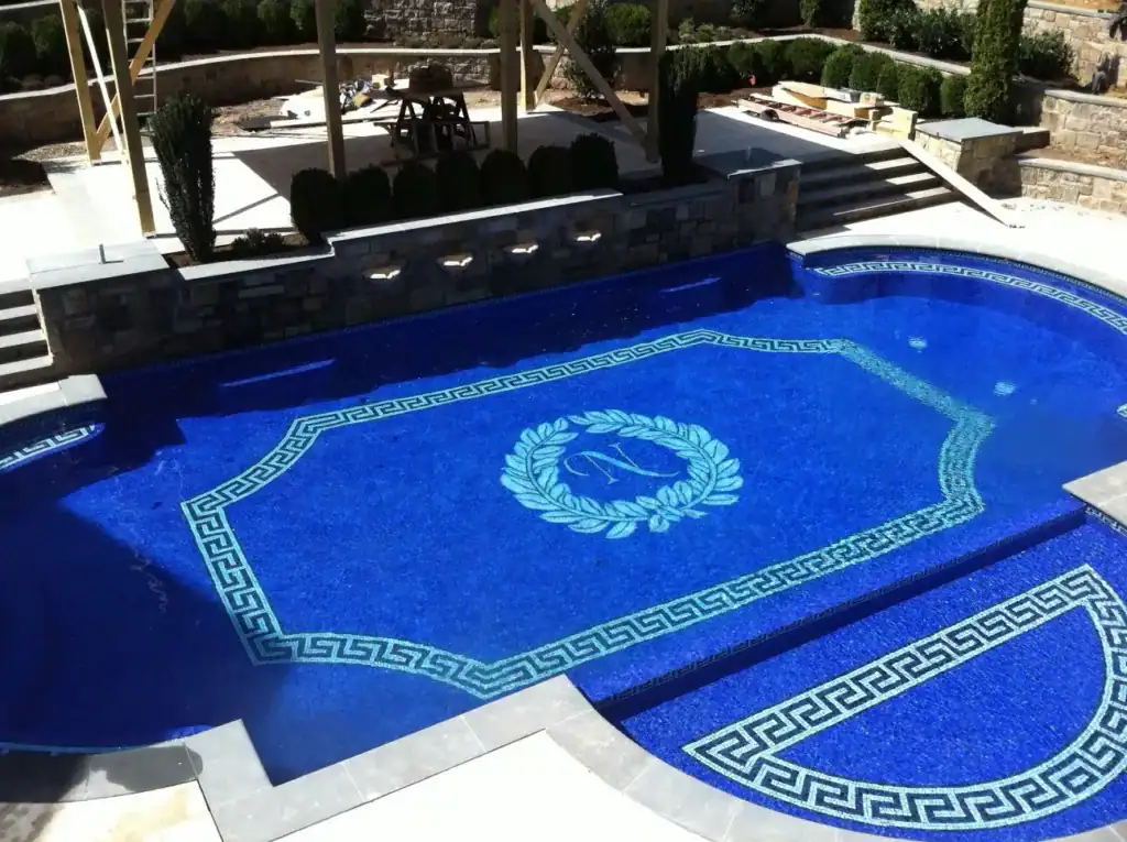 Finished all-tile Dahlia House pool with the laurel wreath and monogram medallion installed