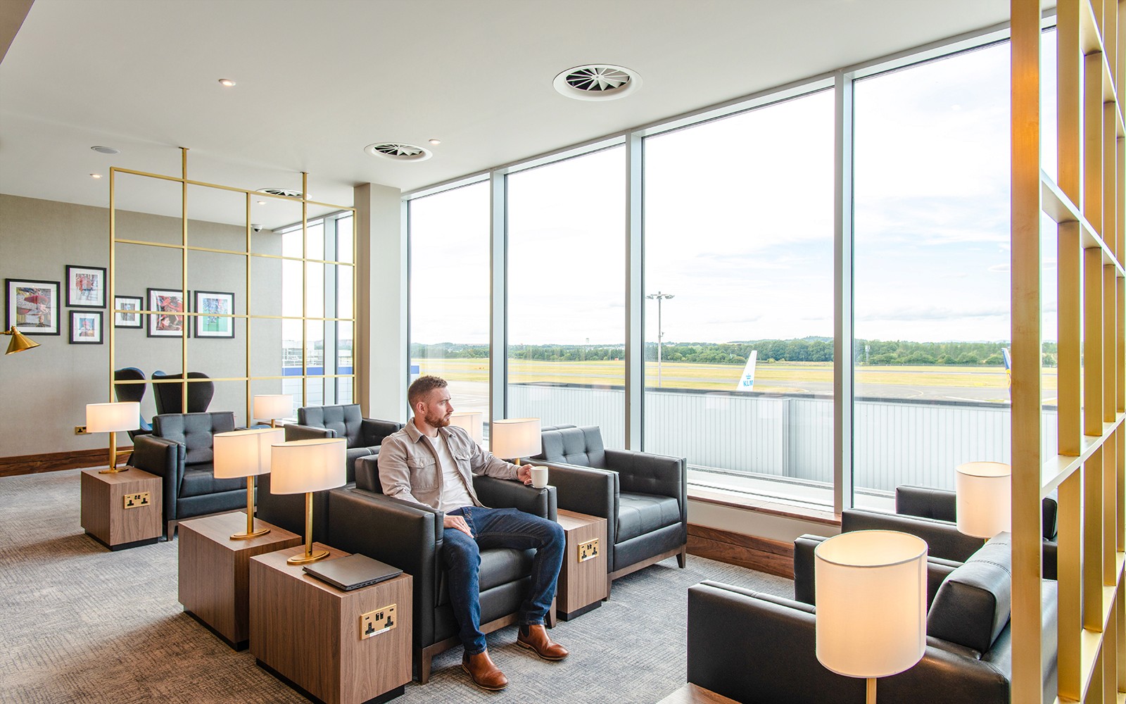 Plaza Premium Lounge seating area at Edinburgh Airport with travelers relaxing.