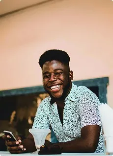 a young man smiling showing teeth