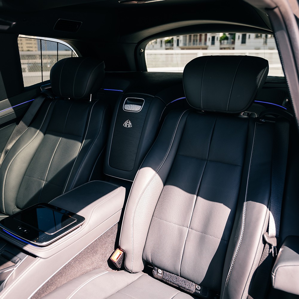 Executive rear seating area of the Mercedes-Maybach GLS 600, showcasing spaciousness and rear entertainment screens.