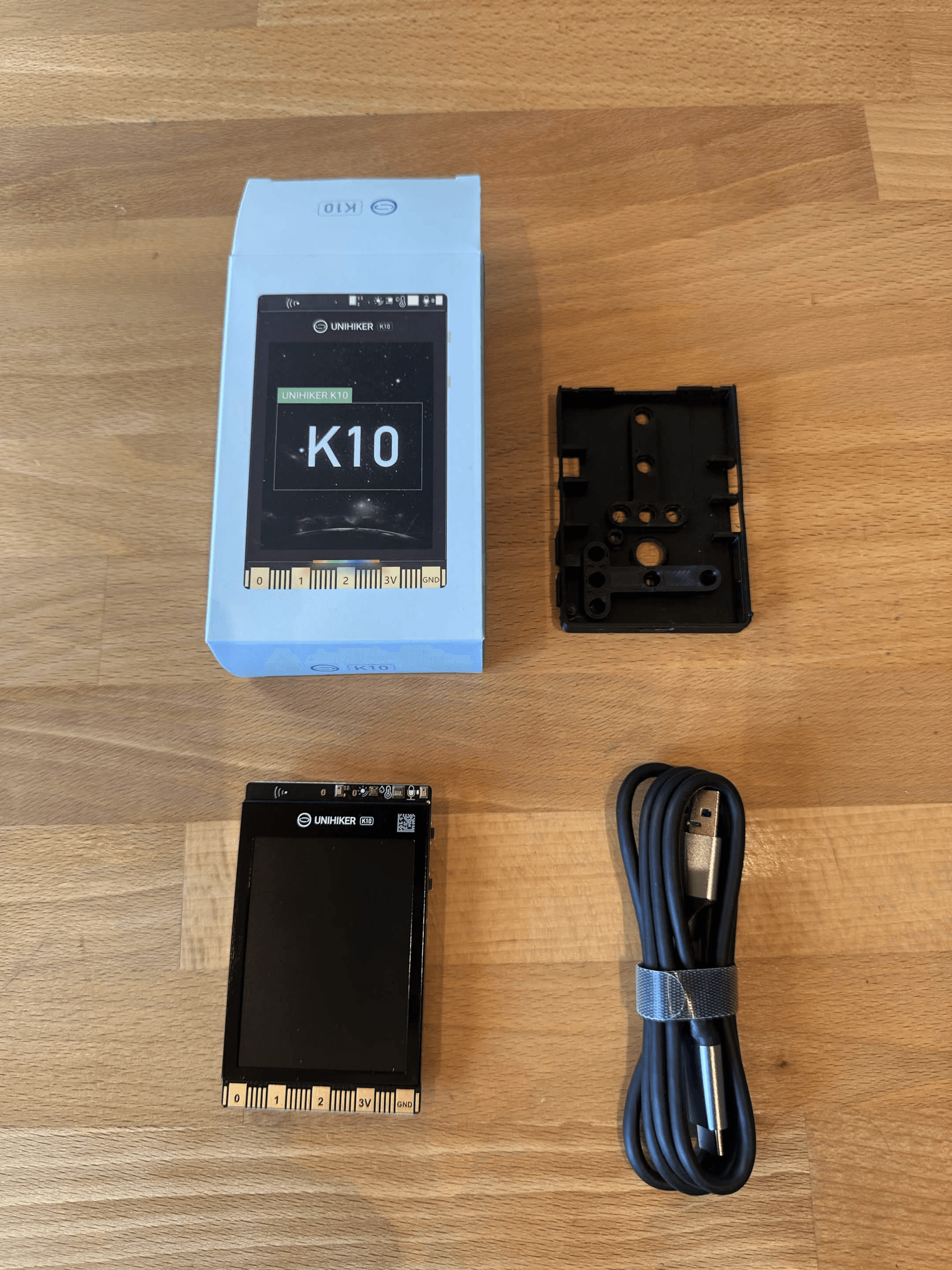 UNIHIKER K10 box contents with the development board, USB-C cable and packaging.