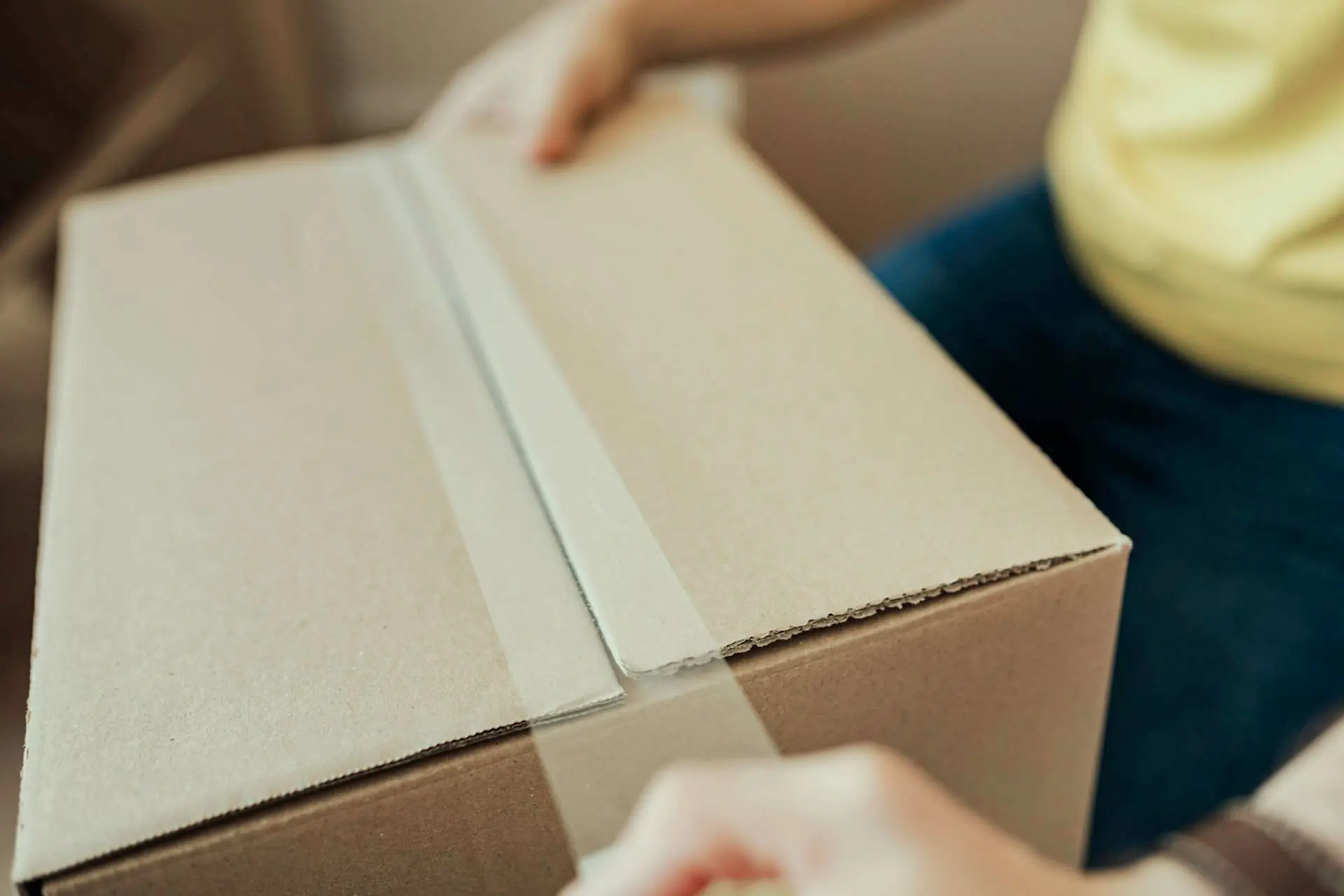 Close up of a person closing a box.
