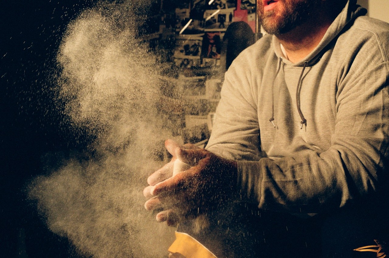 a man in a gym holding a rope