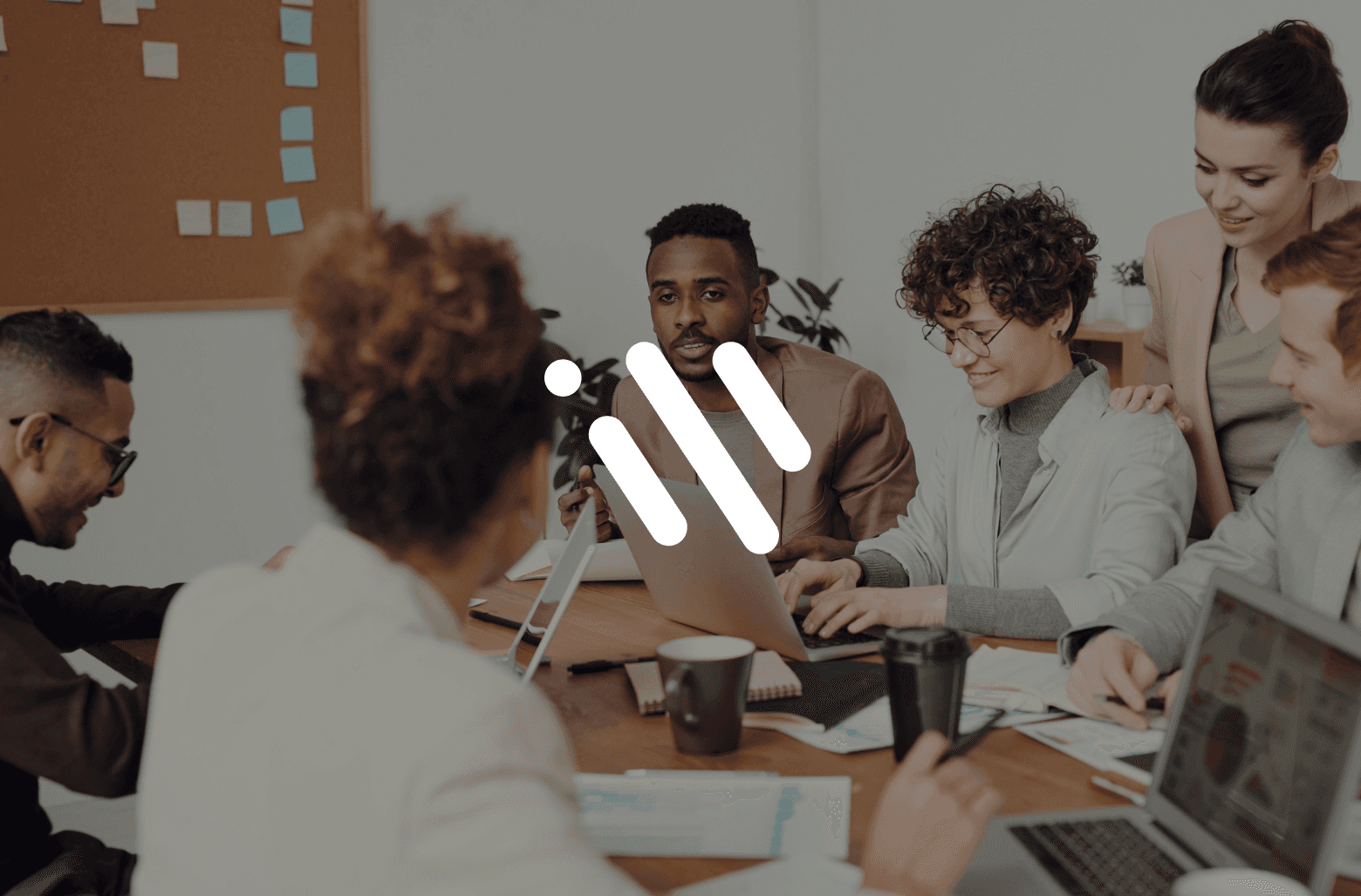 Team collaborating around laptop during project meeting