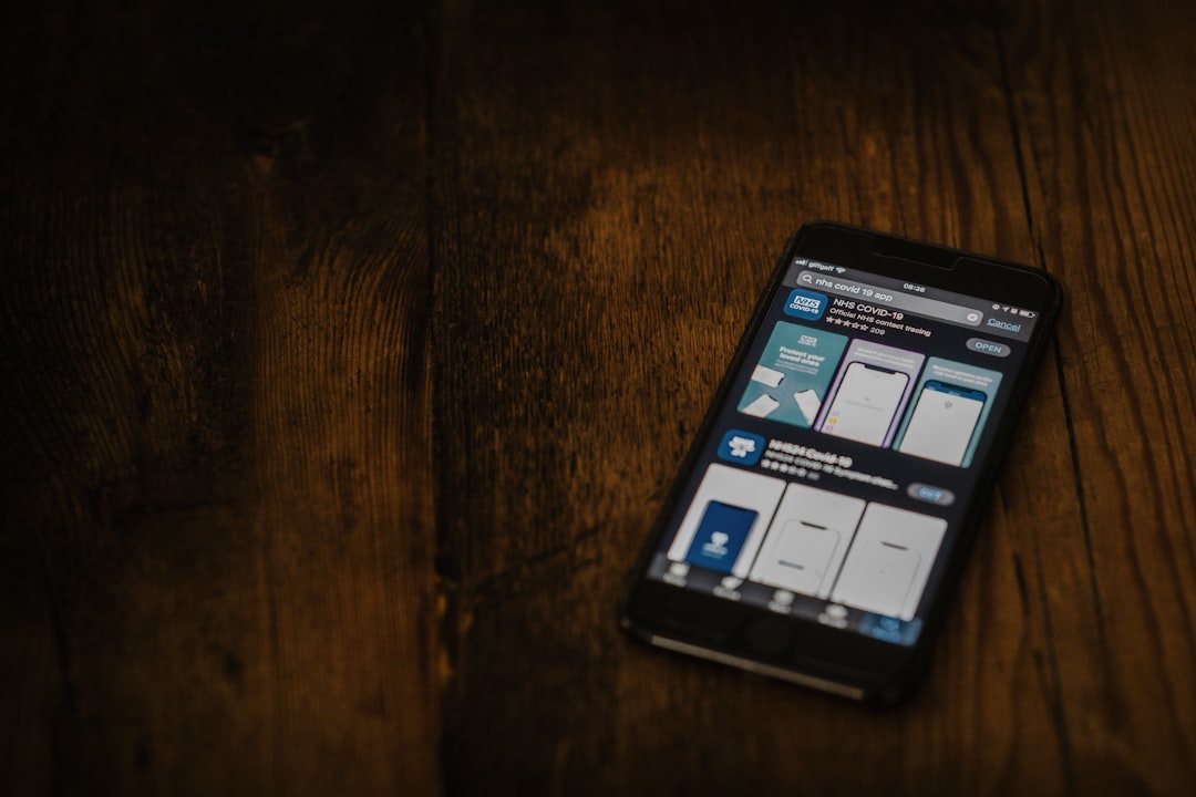 black android smartphone on brown wooden table