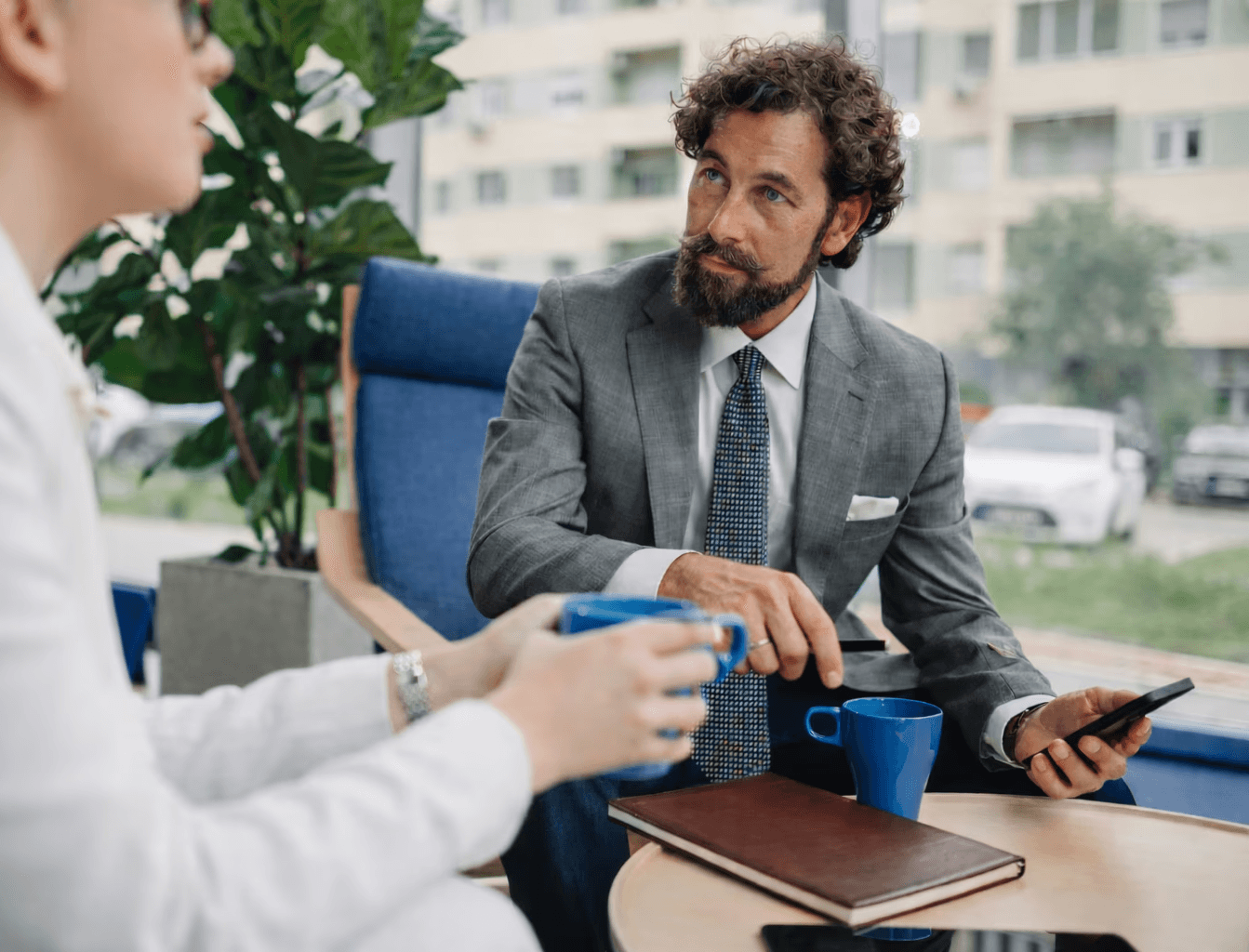 a group of people sitting around a white table