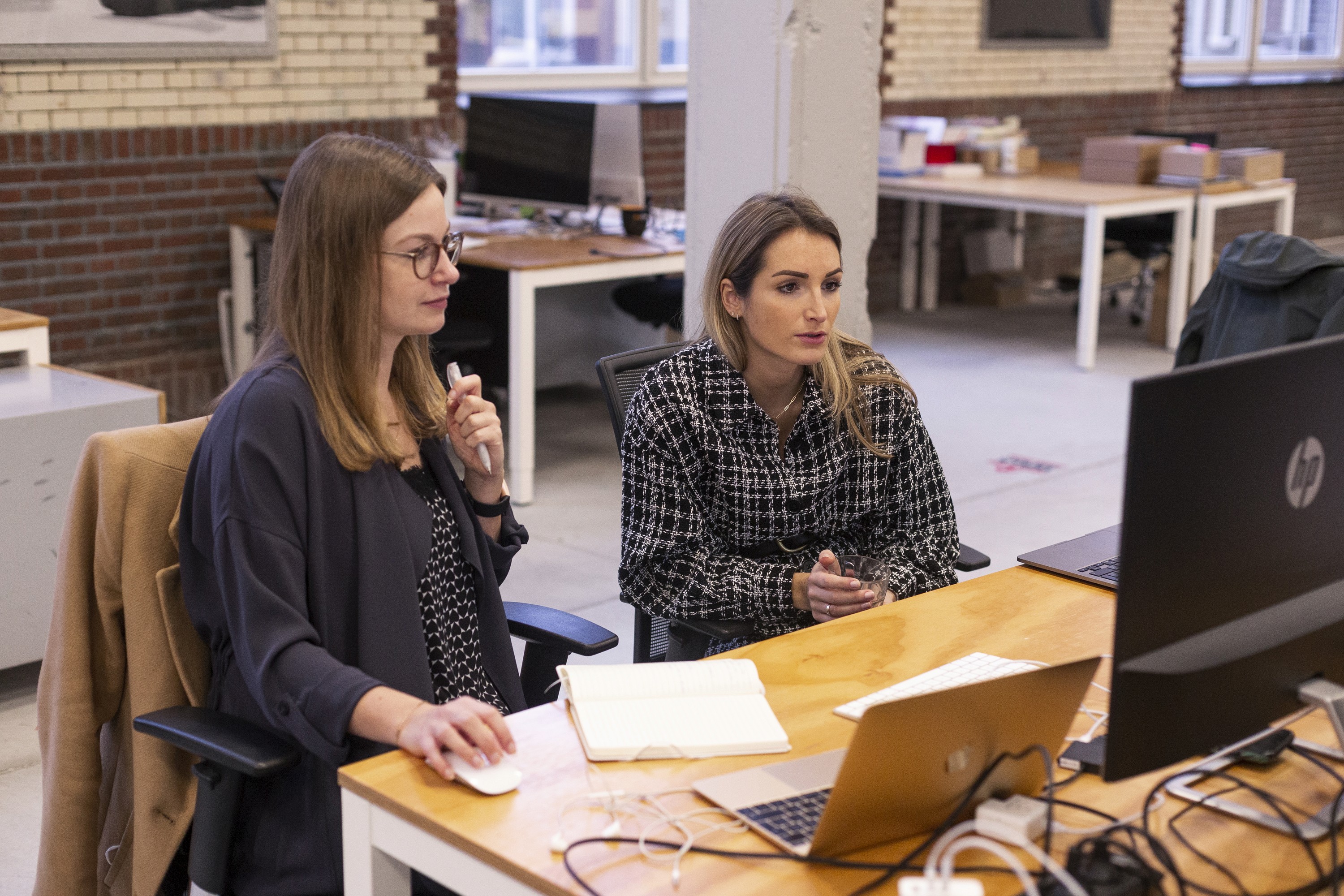 two people discutting matters at a computer desk