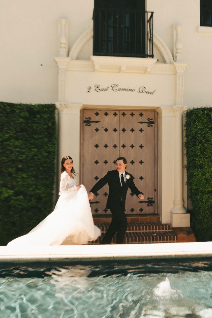     Fort Lauderdale wedding photographer captures newlyweds posing outside a luxury estate in an editorial wedding portrait.