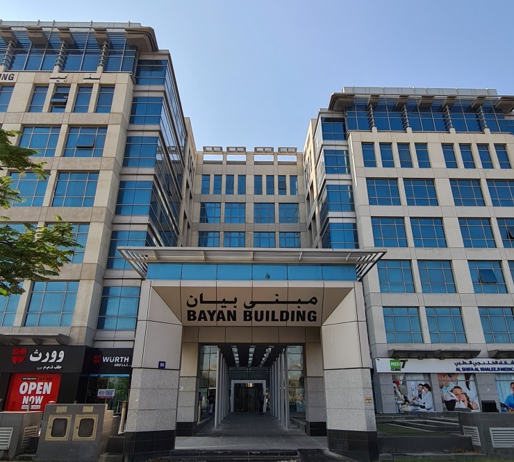 Main entrance of Bayan Building, a prime commercial property for lease managed by expert real estate agents.