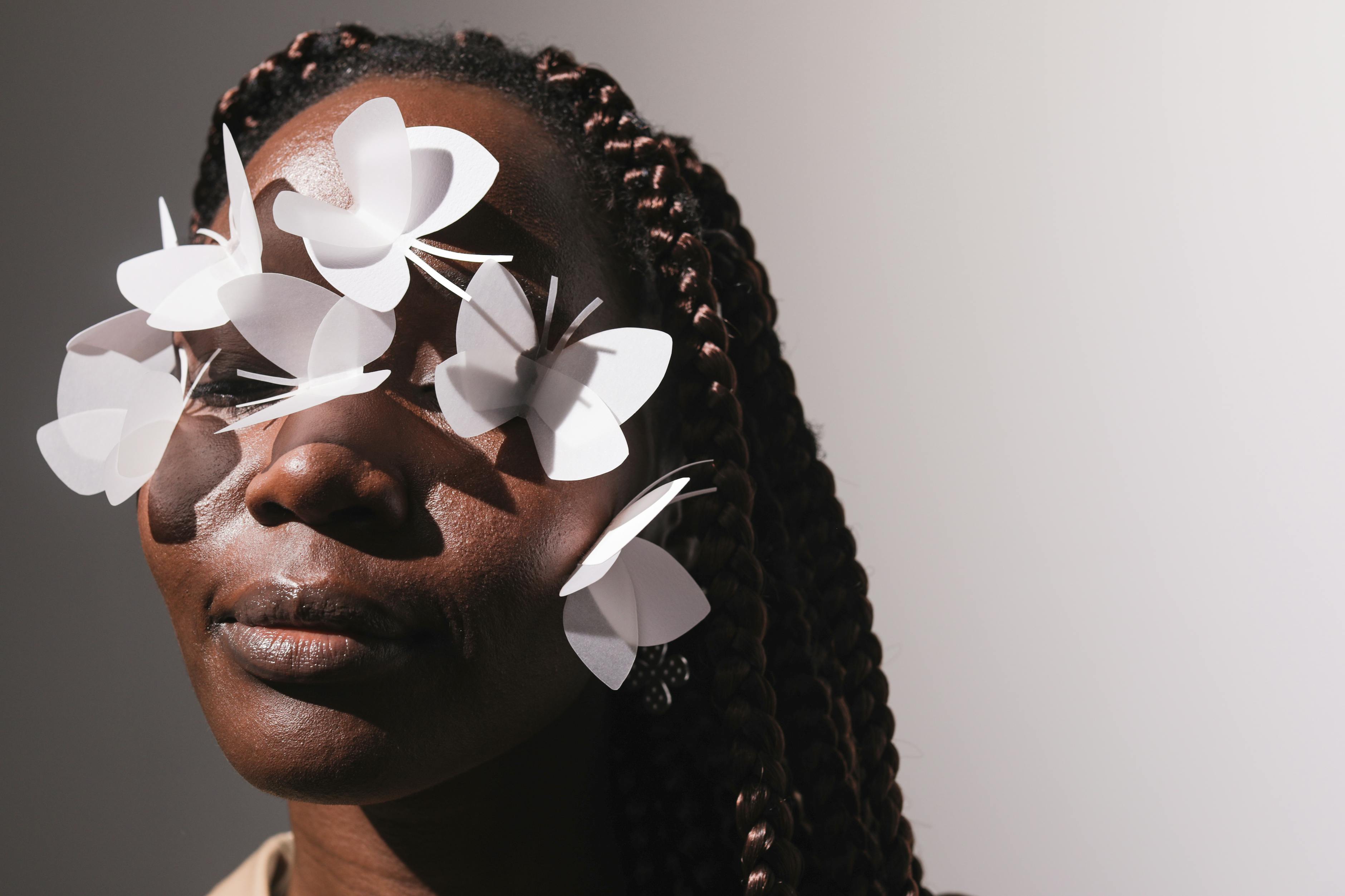 Woman with paper butterflys on her eyes