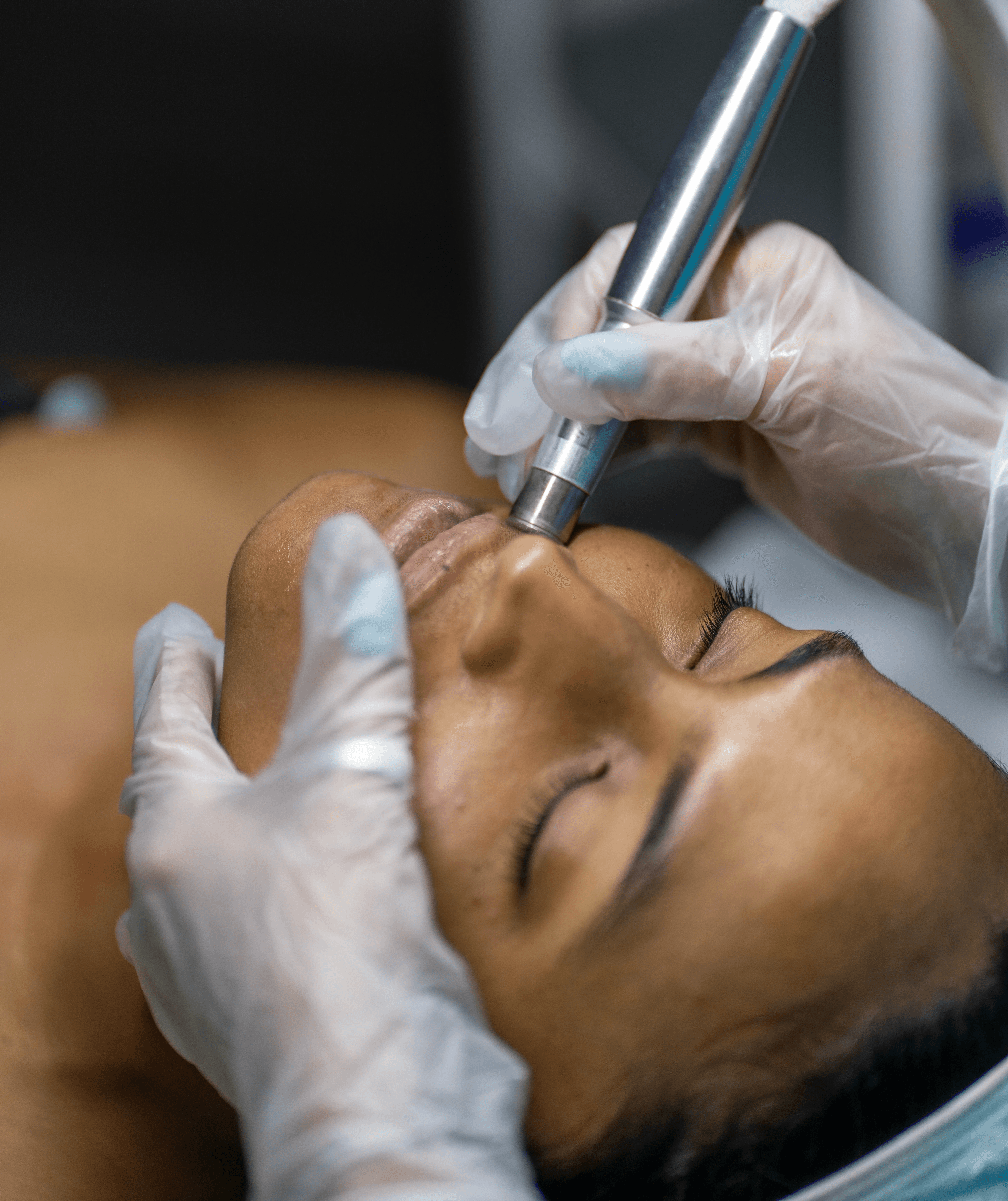 Facial treatment with brush applying white cream to face