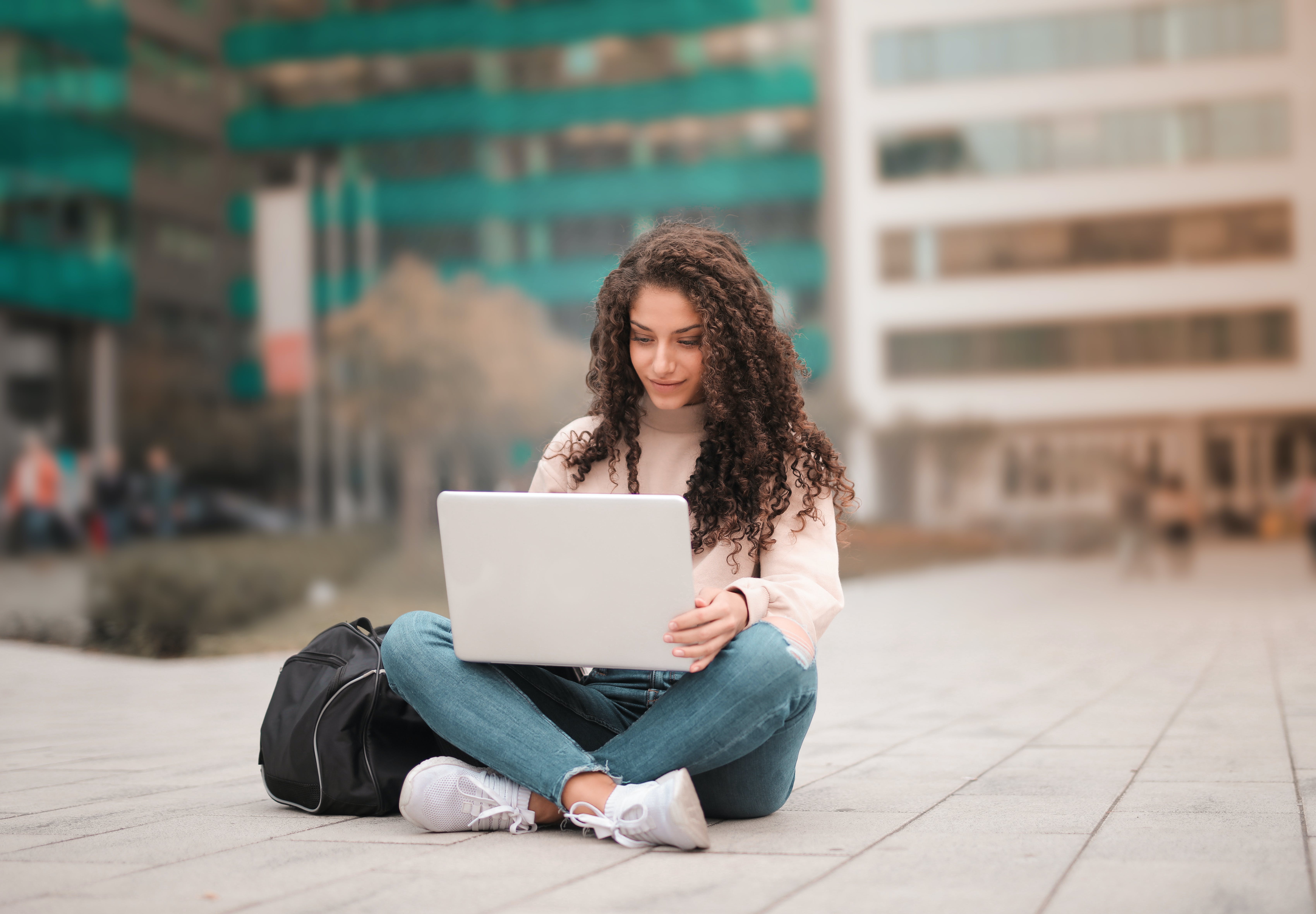 Woman using laptop balancing quality and quantity for cold emails