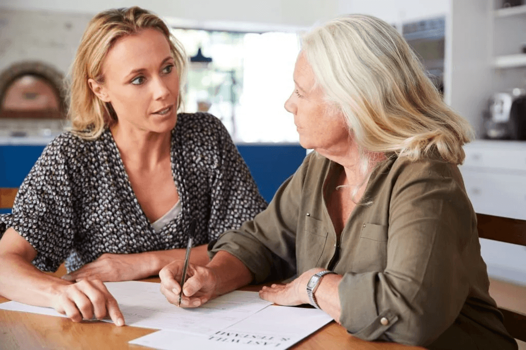 Woman chatting with her mom, signing paperwork