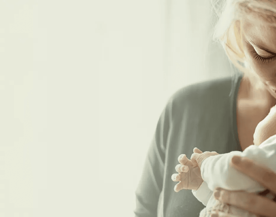 Woman with her baby representing the postpartum care path