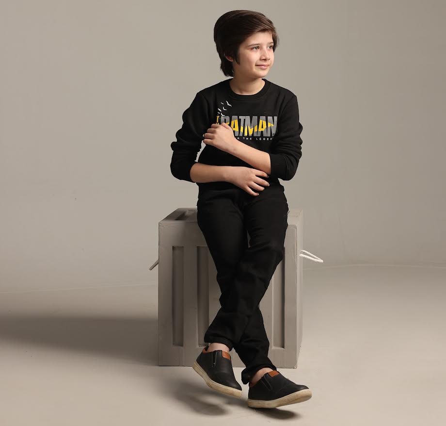 Kid sit on stole in stylish pose